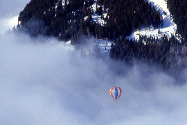 Hot Air Balloon above the sea of fog and clowds