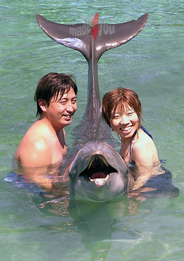 Smiling with dolphin for the photoalbum