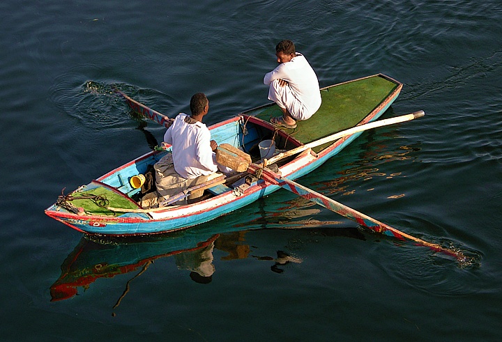 Fishermen with rowboat on the river Nile near Assuan